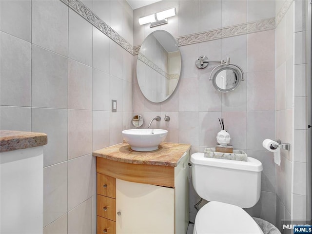 250 Gorge Rd Unit 23I, Cliffside Park, NJ 07010 - half bath featuring tile walls, vanity, and tasteful backsplash