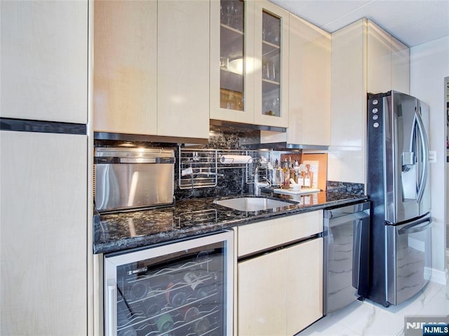 250 Gorge Rd Unit 23I, Cliffside Park, NJ 07010 - kitchen featuring stainless steel appliances, beverage cooler, dark stone countertops, decorative backsplash, and glass insert cabinets