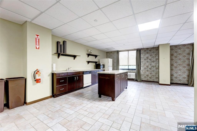 1265 15th St Unit 4C, Fort Lee, NJ 07024 - kitchen featuring white appliances, light countertops, a kitchen island, a paneled ceiling, and dark brown cabinetry