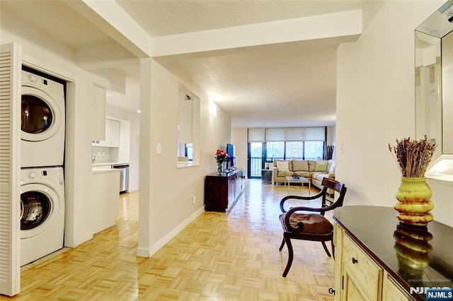 1265 15th St Unit 4C, Fort Lee, NJ 07024 - laundry area with stacked washing machine and dryer and baseboards