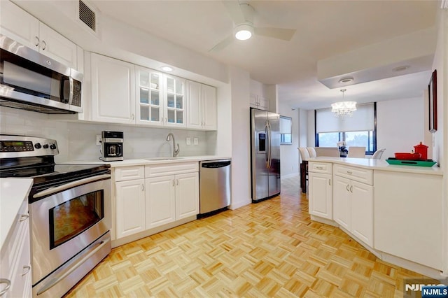 1265 15th St Unit 4C, Fort Lee, NJ 07024 - kitchen with stainless steel appliances, tasteful backsplash, light countertops, and a chandelier