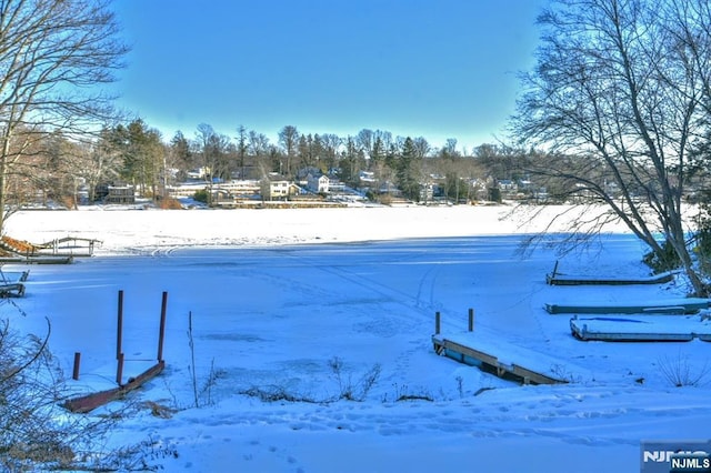 584 N Lake Shr, West Milford, NJ 07421 - yard covered in snow featuring view of wooded area