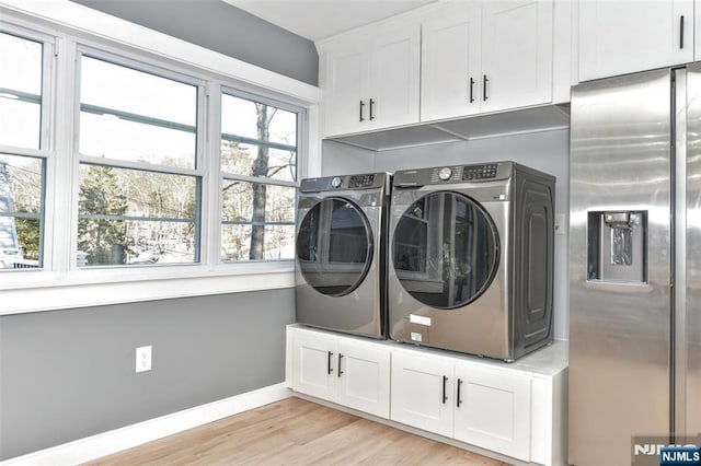 584 N Lake Shr, West Milford, NJ 07421 - laundry room with washing machine and clothes dryer, cabinet space, and light wood-type flooring