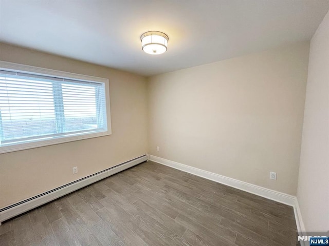 104 Sunset Pl Unit A, Palisades Park, NJ 07650 - spare room with a baseboard radiator and wood finished floors