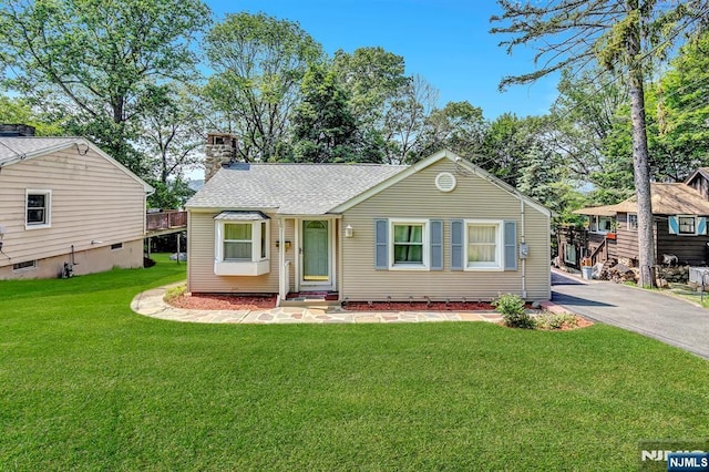 76 Hillside Rd, Sparta, NJ 07871 - view of front facade with a chimney, a front yard, asphalt driveway, and roof with shingles