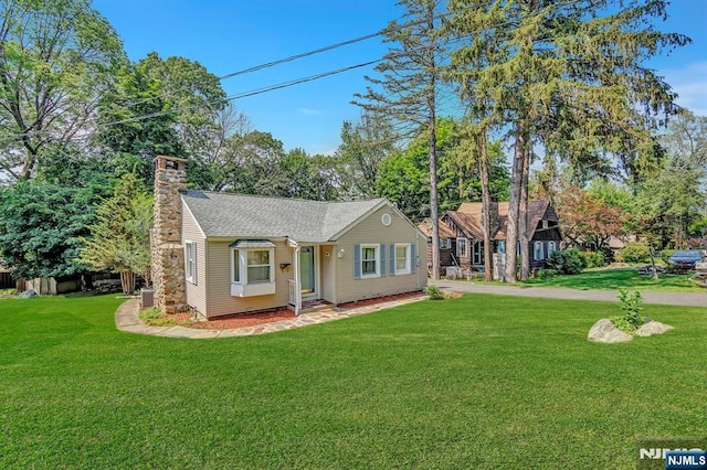 76 Hillside Rd, Sparta, NJ 07871 - view of front of home with a front lawn, a chimney, and roof with shingles