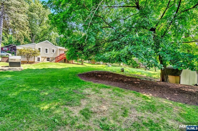 76 Hillside Rd, Sparta, NJ 07871 - view of green lawn featuring stairs and an outdoor structure