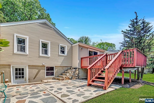 76 Hillside Rd, Sparta, NJ 07871 - rear view of property featuring stairway, a patio, a deck, and a lawn