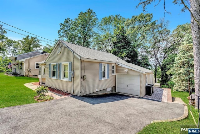 76 Hillside Rd, Sparta, NJ 07871 - view of home's exterior featuring asphalt driveway, a lawn, a garage, and roof with shingles