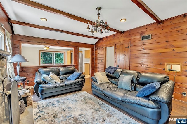 76 Hillside Rd, Sparta, NJ 07871 - living room with wood walls, a chandelier, and wood finished floors