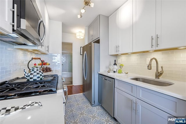 2077 Center Ave Unit 19C, Fort Lee, NJ 07024 - kitchen featuring stainless steel appliances, light countertops, tasteful backsplash, and light tile patterned floors