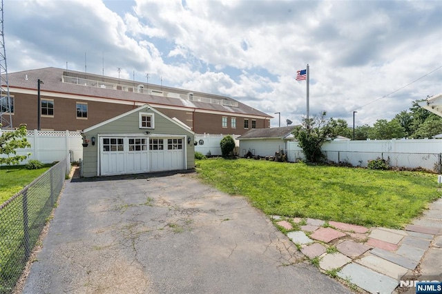 5 Rhinesmith Ave, Wanaque, NJ 07465 - view of front of property with asphalt driveway, a garage, and an outbuilding