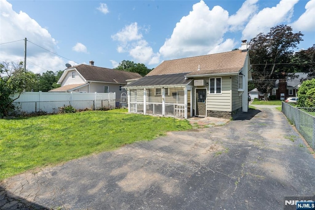 5 Rhinesmith Ave, Wanaque, NJ 07465 - back of property with a chimney and a sunroom