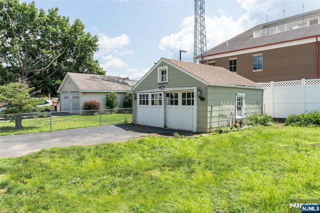 5 Rhinesmith Ave, Wanaque, NJ 07465 - back of house with an outbuilding, a garage, and a shingled roof