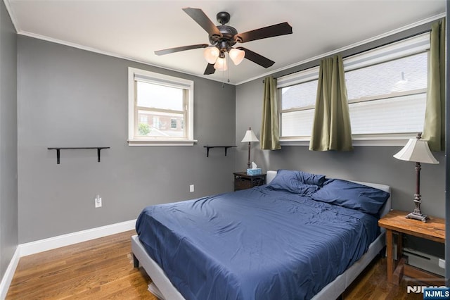 5 Rhinesmith Ave, Wanaque, NJ 07465 - bedroom featuring wood finished floors, a baseboard heating unit, crown molding, multiple windows, and ceiling fan