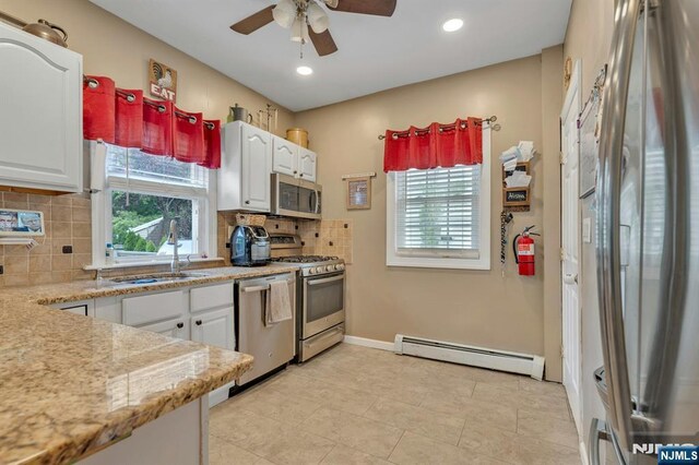 18 Gillies St, Clifton, NJ 07013 - kitchen with a baseboard heating unit, appliances with stainless steel finishes, plenty of natural light, a ceiling fan, and recessed lighting