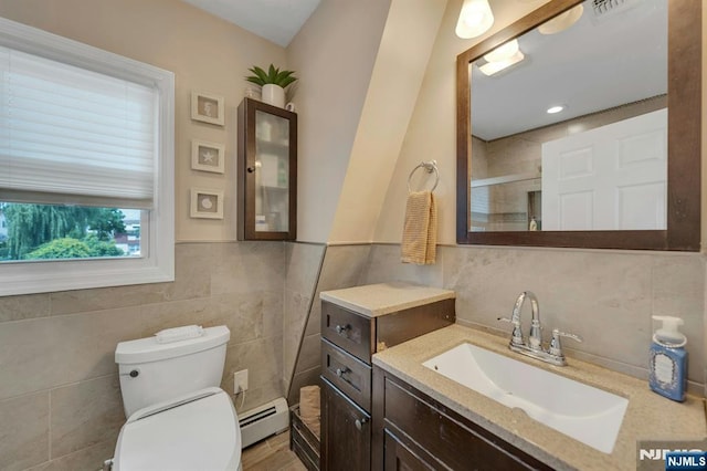 18 Gillies St, Clifton, NJ 07013 - full bath with tile walls, a baseboard heating unit, vanity, an enclosed shower, and wainscoting