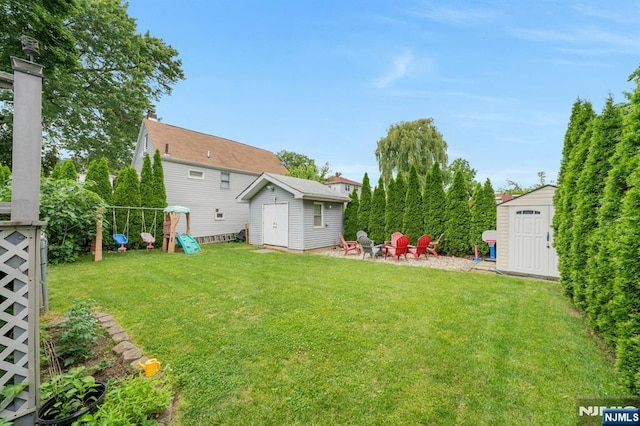 18 Gillies St, Clifton, NJ 07013 - view of green lawn featuring a shed, an outdoor fire pit, and a playground