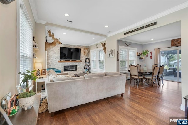 18 Gillies St, Clifton, NJ 07013 - living room featuring dark wood finished floors, healthy amount of natural light, a stone fireplace, ornamental molding, and recessed lighting