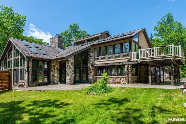 69 Mount Pleasant Rd, Knowlton, NJ 07832 - back of property featuring stone siding, a chimney, a yard, and a deck