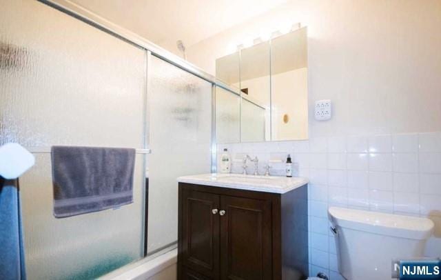 285 Aycrigg Ave Unit 22D, Passaic, NJ 07055 - bathroom featuring vanity and tile walls