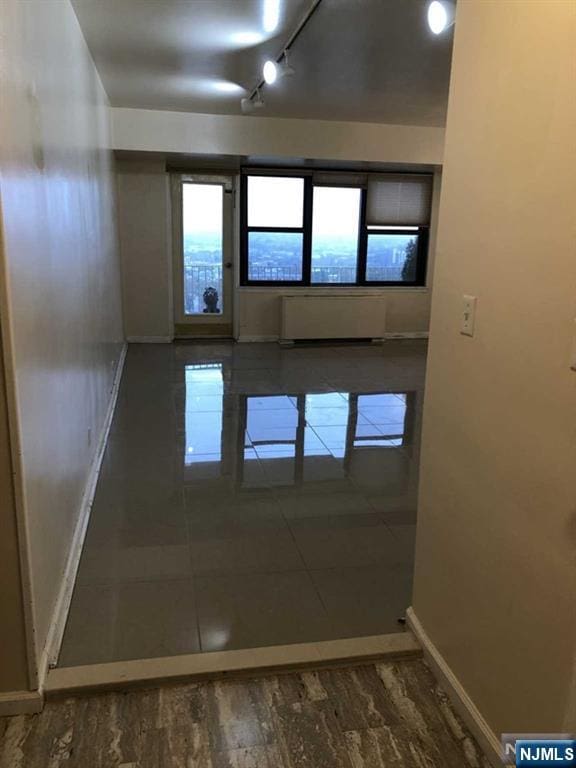 285 Aycrigg Ave Unit 22D, Passaic, NJ 07055 - tiled empty room featuring baseboards and radiator