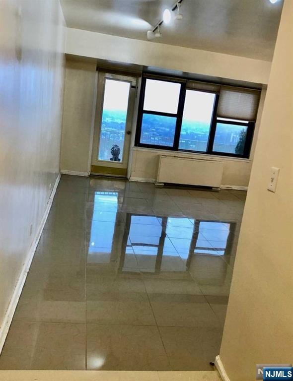 285 Aycrigg Ave Unit 22D, Passaic, NJ 07055 - empty room with radiator heating unit and tile patterned floors