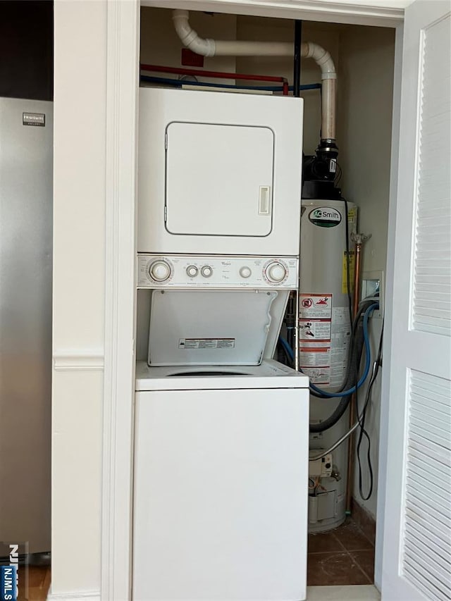 315 7th St Unit 702, Union City, NJ 07087 - laundry area featuring stacked washing machine and dryer, water heater, and tile patterned flooring