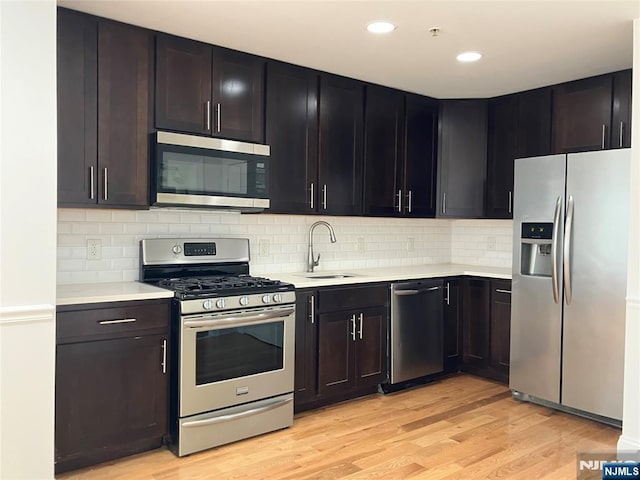 315 7th St Unit 702, Union City, NJ 07087 - kitchen with appliances with stainless steel finishes, light countertops, light wood-type flooring, and recessed lighting