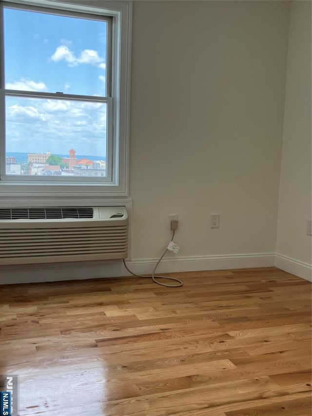 315 7th St Unit 702, Union City, NJ 07087 - unfurnished room featuring light wood-style flooring and an AC wall unit