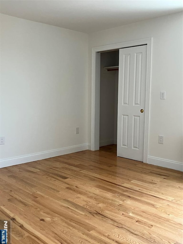 315 7th St Unit 702, Union City, NJ 07087 - unfurnished bedroom with light wood-style floors and a closet