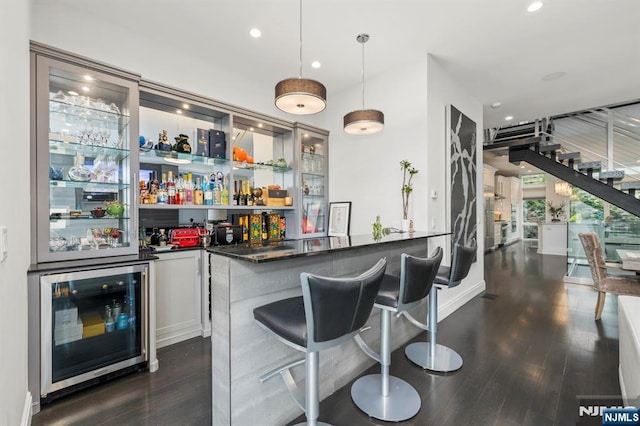 12 Hooks Ln, Edgewater, NJ 07020 - indoor wet bar with beverage cooler, dark wood-type flooring, recessed lighting, and hanging light fixtures