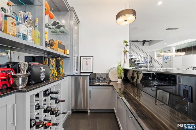 12 Hooks Ln, Edgewater, NJ 07020 - bar with dark wood-style flooring, decorative light fixtures, and fridge