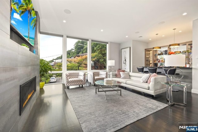 12 Hooks Ln, Edgewater, NJ 07020 - living area with floor to ceiling windows, wood finished floors, a glass covered fireplace, and recessed lighting