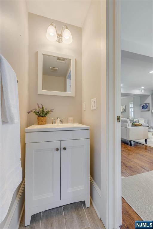 20 Brighton Ave, Bloomfield, NJ 07003 - bathroom with wood finished floors and vanity