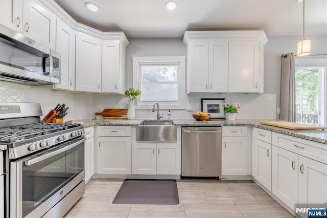 20 Brighton Ave, Bloomfield, NJ 07003 - kitchen featuring appliances with stainless steel finishes, white cabinetry, recessed lighting, tasteful backsplash, and light stone countertops