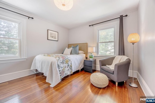 20 Brighton Ave, Bloomfield, NJ 07003 - bedroom featuring multiple windows, wood finished floors, and crown molding