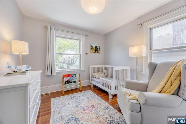 20 Brighton Ave, Bloomfield, NJ 07003 - bedroom with a nursery area, wood finished floors, and crown molding