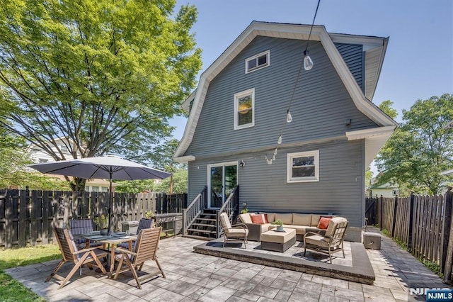 20 Brighton Ave, Bloomfield, NJ 07003 - back of property featuring an outdoor living space, a patio, a gambrel roof, and a fenced backyard