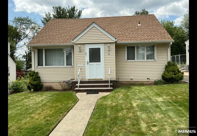 67 Melody Hill Rd, Clifton, NJ 07013 - bungalow-style house with entry steps, a front lawn, and roof with shingles