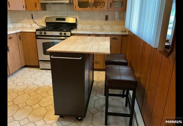 67 Melody Hill Rd, Clifton, NJ 07013 - kitchen featuring gas range, ventilation hood, and decorative backsplash