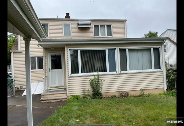 67 Melody Hill Rd, Clifton, NJ 07013 - view of front of house featuring a front lawn, a chimney, and entry steps