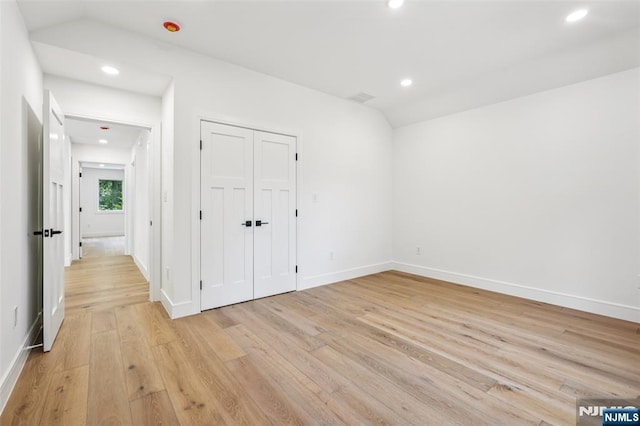 492 Oaktree Rd, Oradell, NJ 07649 - unfurnished bedroom with light wood-style floors, recessed lighting, vaulted ceiling, and a closet