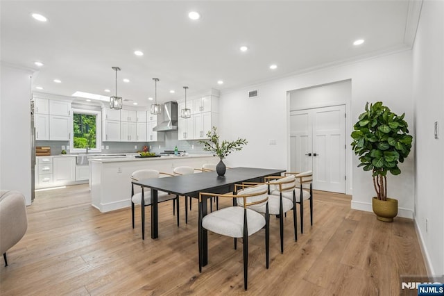 492 Oaktree Rd, Oradell, NJ 07649 - dining room featuring light wood-style floors, crown molding, and recessed lighting