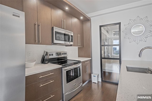 6401 Park Ave Unit 401, West New York, NJ 07093 - kitchen featuring stainless steel appliances, dark wood-style floors, dark brown cabinetry, recessed lighting, and light stone countertops