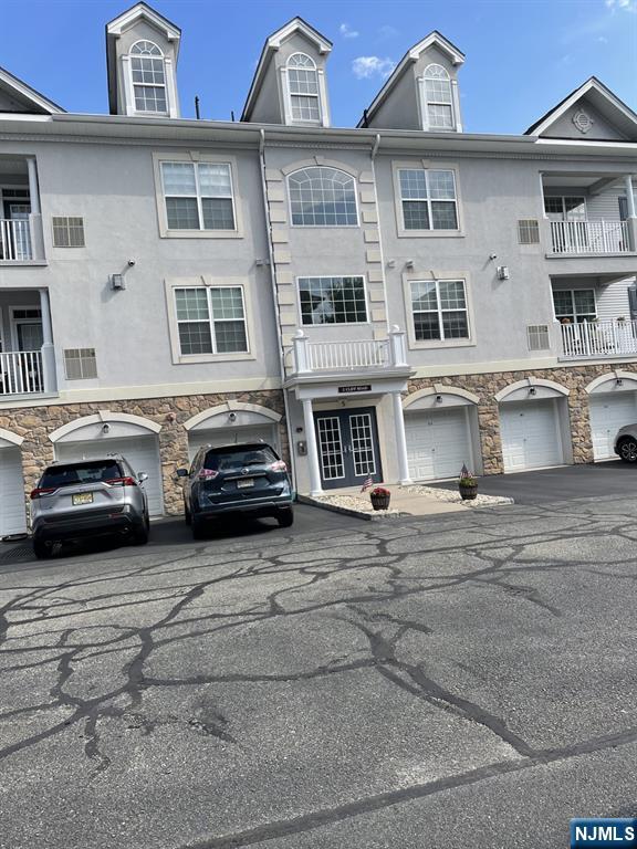 5 Cliff Rd Unit C1, Woodland Park, NJ 07424 - view of front facade featuring stone siding, stucco siding, and driveway