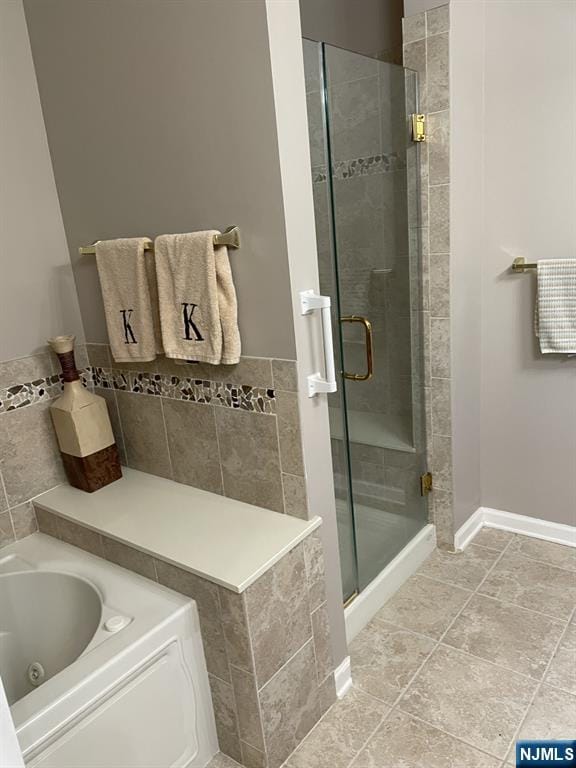 5 Cliff Rd Unit C1, Woodland Park, NJ 07424 - full bath with a shower stall, tile walls, a jetted tub, and tile patterned flooring