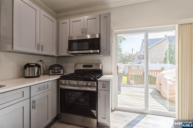 187 Wallington Ave, Wallington, NJ 07057 - kitchen with appliances with stainless steel finishes, gray cabinets, light countertops, and ornamental molding