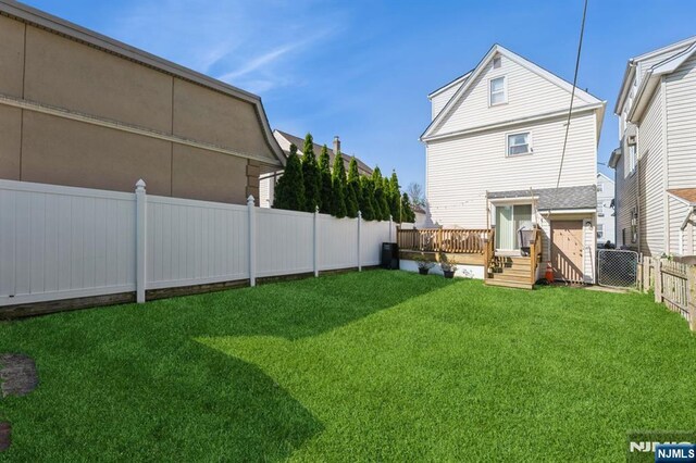 187 Wallington Ave, Wallington, NJ 07057 - back of property with a fenced backyard and a wooden deck