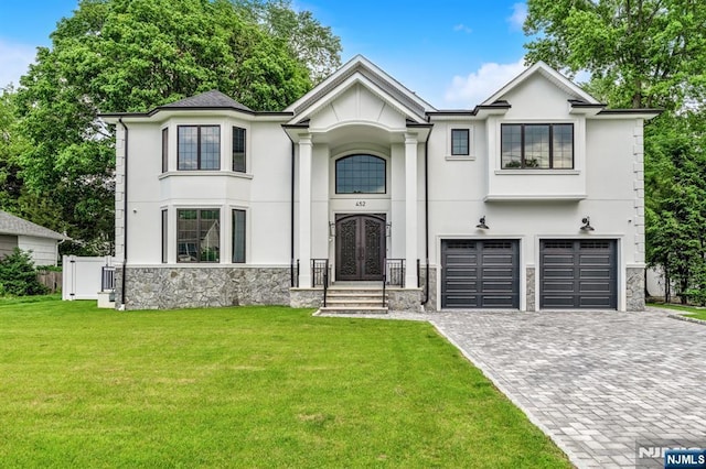452 Oregon St, Paramus, NJ 07652 - view of front of property with french doors, decorative driveway, an attached garage, and stucco siding